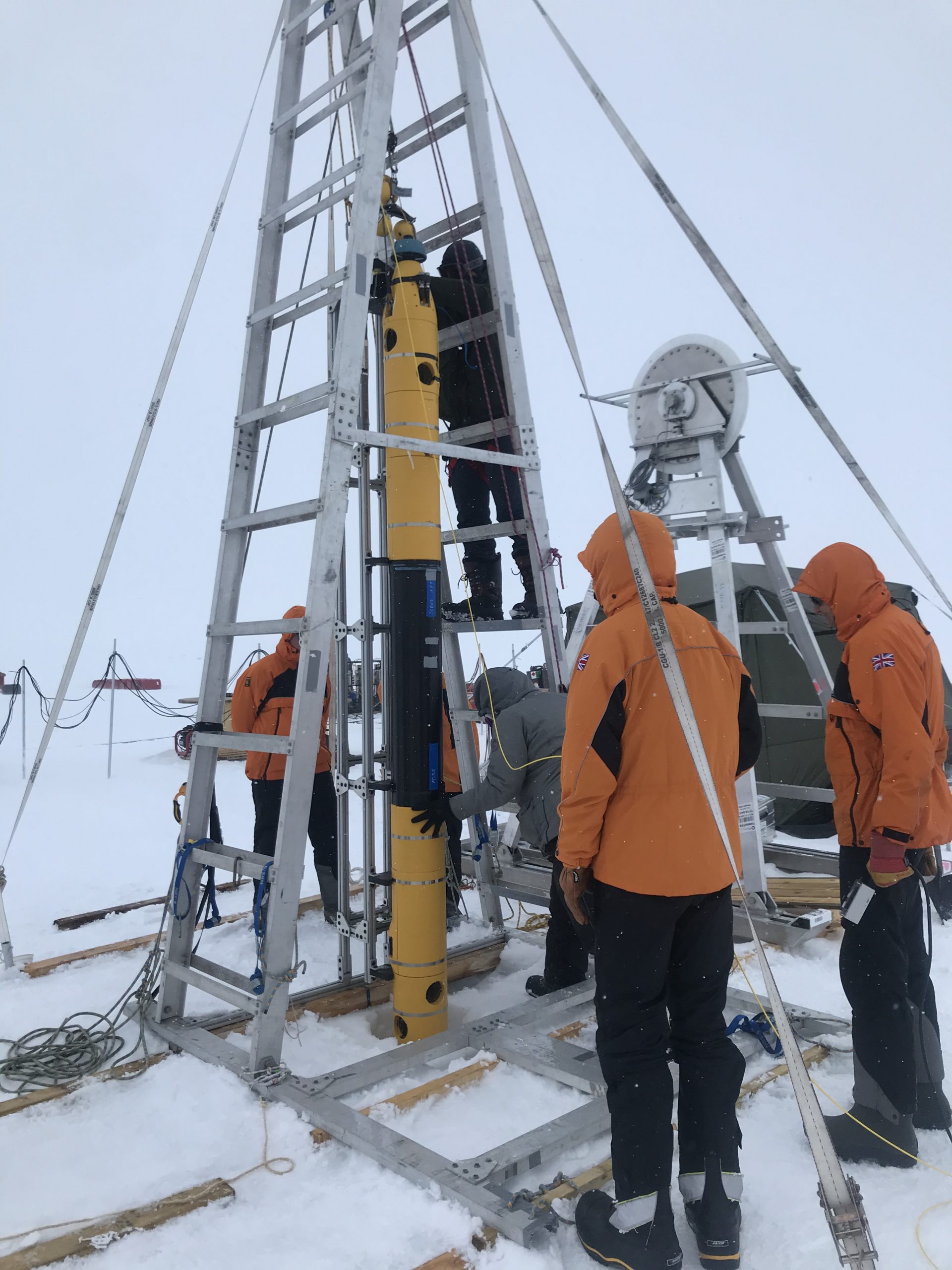 Icefin team members and BAS team assess Icefin deployment.